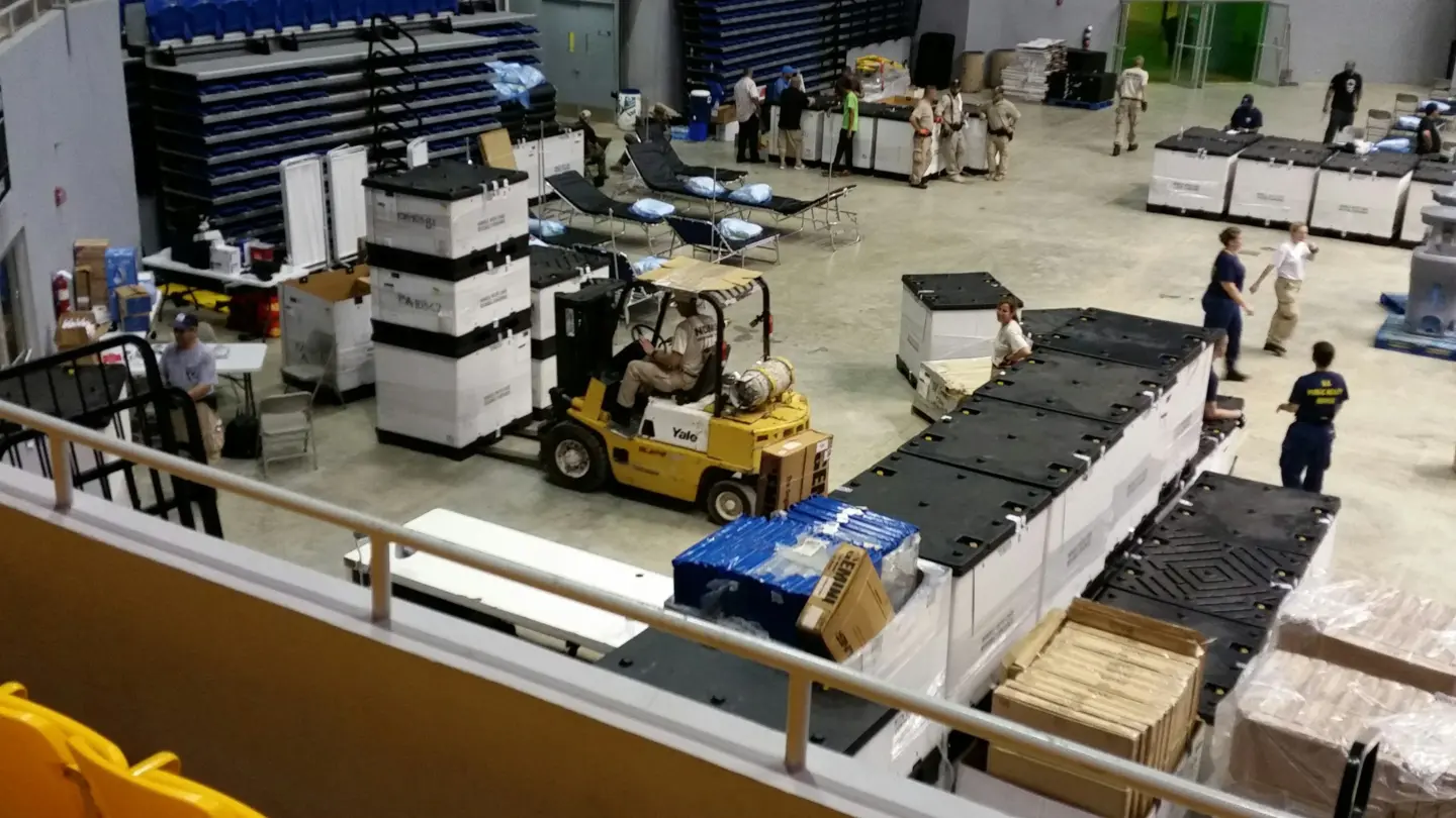 Warehouse operations with forklift moving heavy-duty industrial crates and pallets